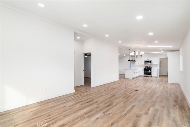 unfurnished living room featuring ornamental molding, ceiling fan with notable chandelier, and light hardwood / wood-style floors