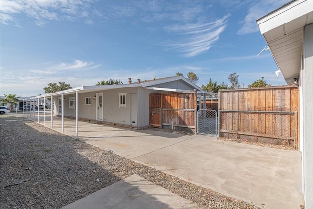 back of house with a carport