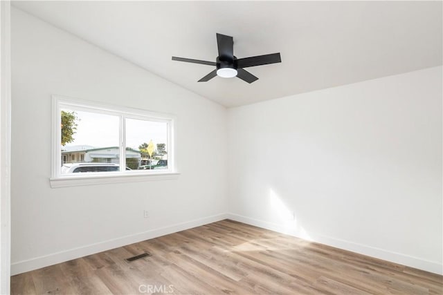 unfurnished room featuring vaulted ceiling, light hardwood / wood-style floors, and ceiling fan