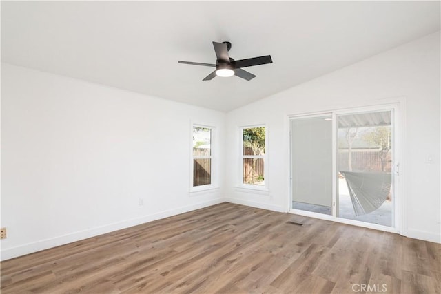 unfurnished room with lofted ceiling, wood-type flooring, and ceiling fan