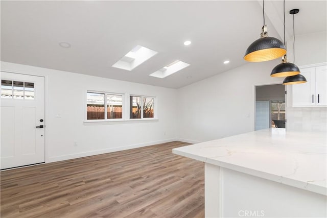 interior space featuring wood-type flooring and lofted ceiling