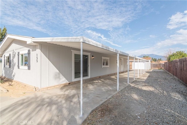 rear view of property featuring a patio and a mountain view