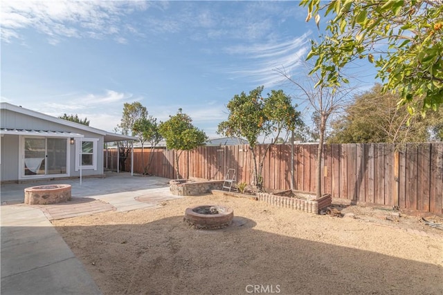 view of yard featuring a patio area and an outdoor fire pit