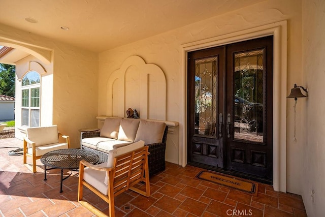 entrance to property featuring a patio area and french doors