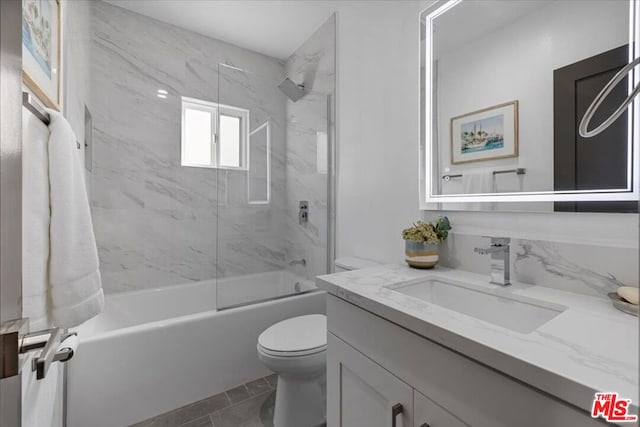 full bathroom with vanity, toilet, and tiled shower / bath