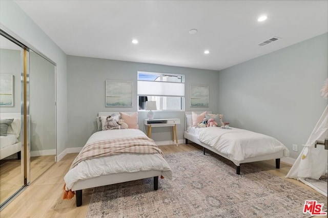 bedroom featuring light hardwood / wood-style flooring and a closet