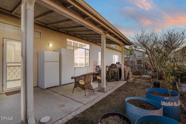 view of patio terrace at dusk