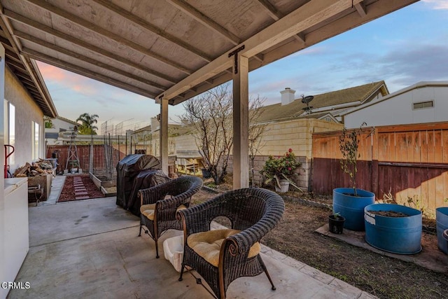 view of patio terrace at dusk