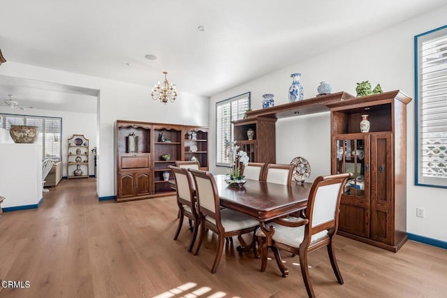 dining room featuring light hardwood / wood-style floors and a chandelier