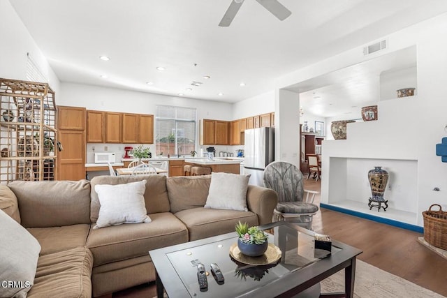 living room with hardwood / wood-style flooring and ceiling fan