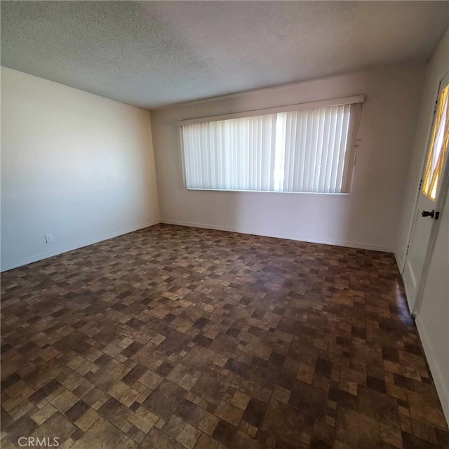 empty room featuring a textured ceiling