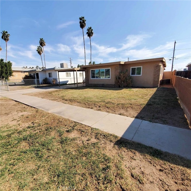 ranch-style home with a front yard