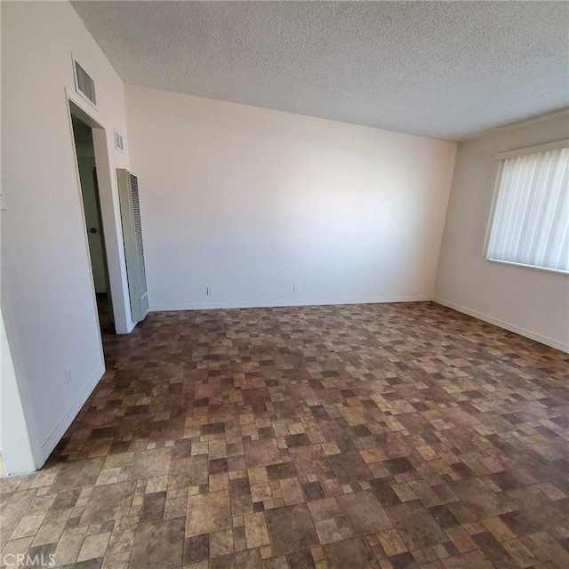 empty room with a textured ceiling