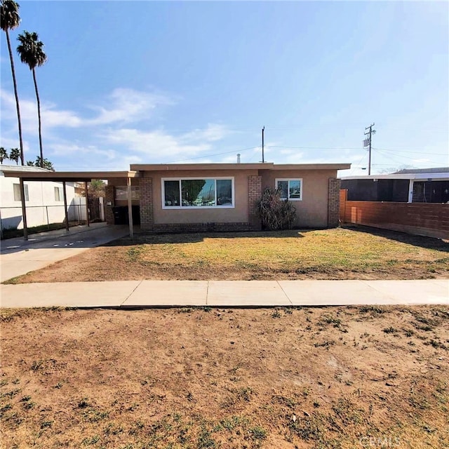 single story home featuring a carport and a front lawn