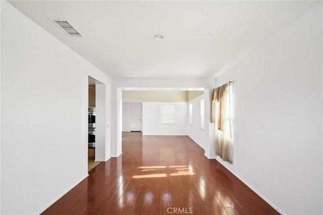 unfurnished room with dark hardwood / wood-style floors