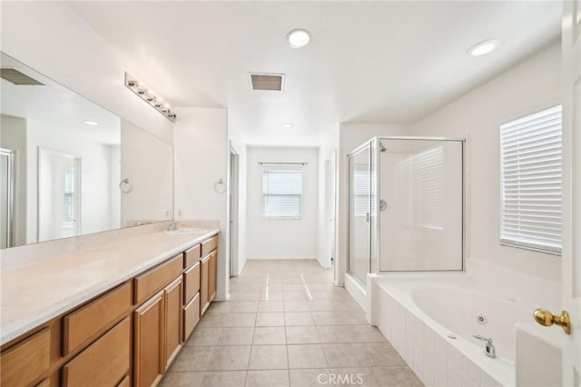 bathroom featuring tile patterned floors, vanity, and shower with separate bathtub