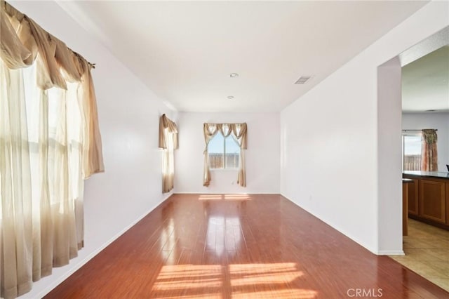 unfurnished room featuring dark hardwood / wood-style flooring