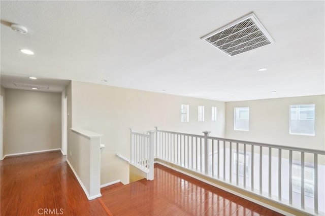 hall with hardwood / wood-style floors