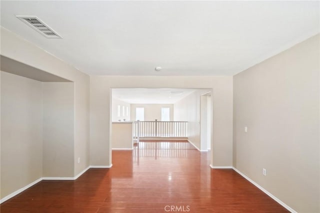 unfurnished room featuring dark wood-type flooring