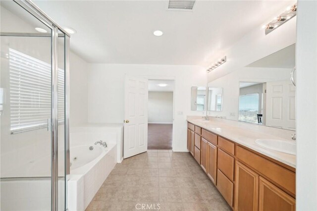 bathroom featuring vanity, tile patterned floors, and plus walk in shower