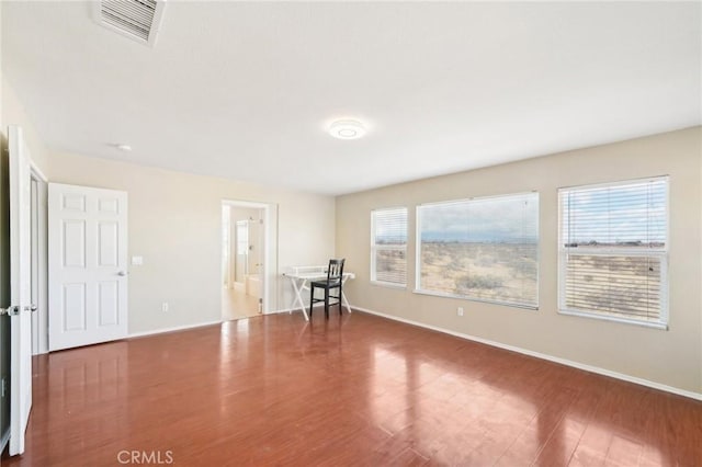 spare room featuring dark hardwood / wood-style floors