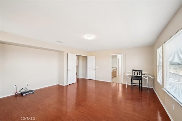 unfurnished room featuring dark hardwood / wood-style flooring