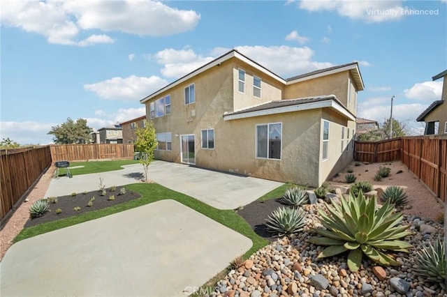 back of property featuring a patio area