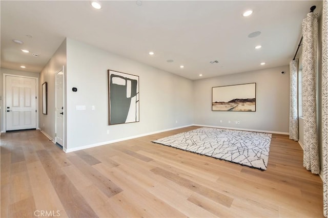 empty room with light hardwood / wood-style flooring