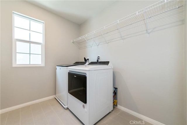 clothes washing area featuring washer and clothes dryer