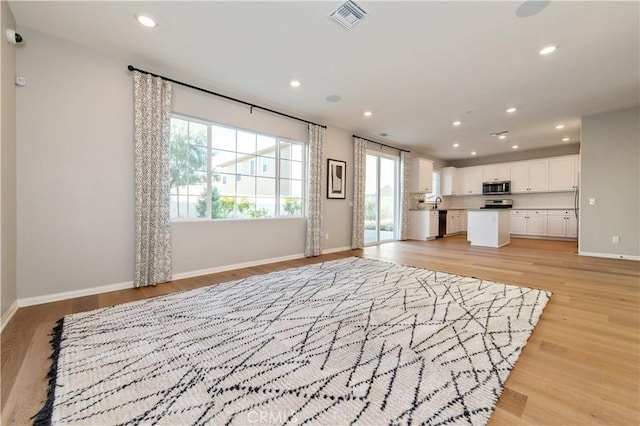 unfurnished living room featuring light hardwood / wood-style flooring