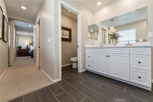 bathroom featuring vanity and toilet