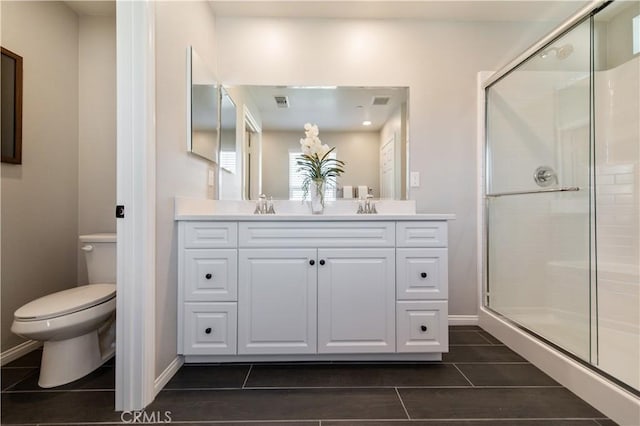 bathroom with vanity, an enclosed shower, and toilet