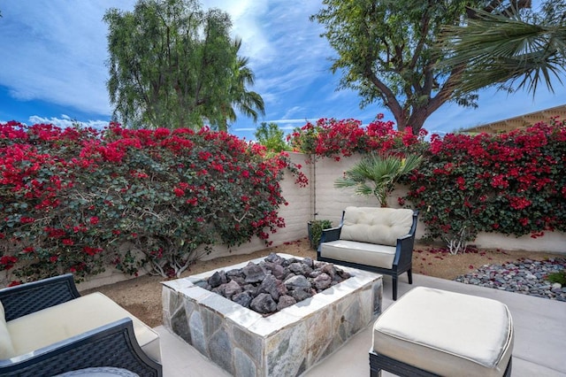 view of patio / terrace featuring an outdoor fire pit