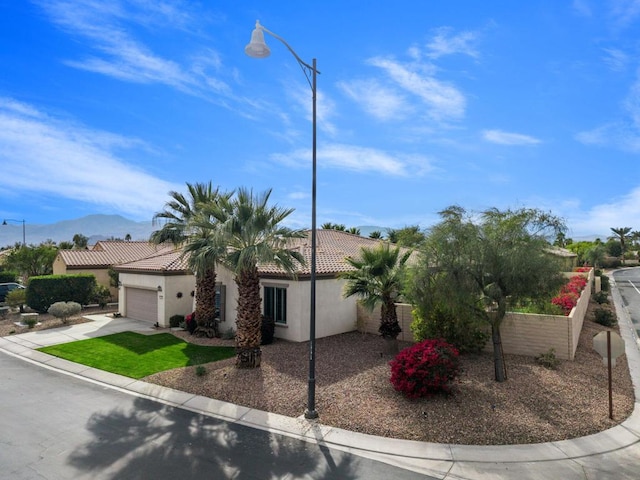 view of front of property with a garage and a mountain view