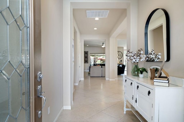 tiled entryway featuring ceiling fan