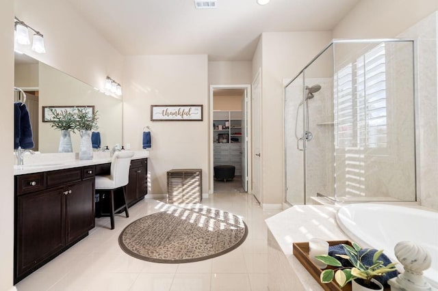 bathroom featuring independent shower and bath, vanity, and tile patterned flooring