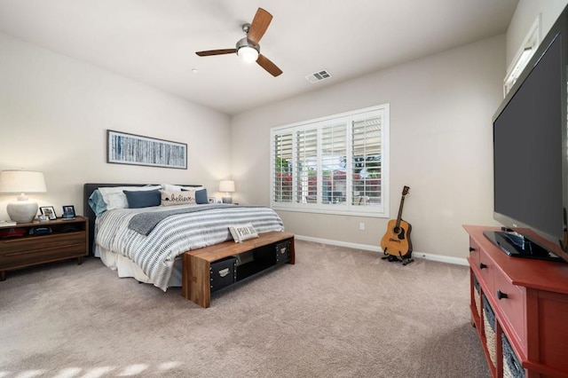 bedroom with ceiling fan and light colored carpet