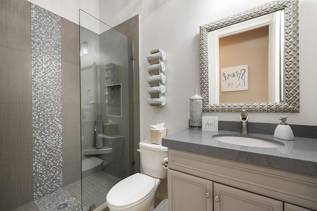 bathroom with walk in shower, vanity, and toilet