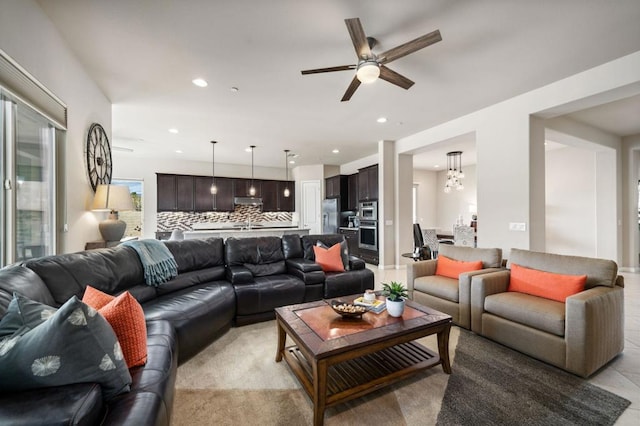 living room featuring ceiling fan with notable chandelier