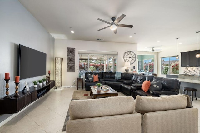 tiled living room with ceiling fan