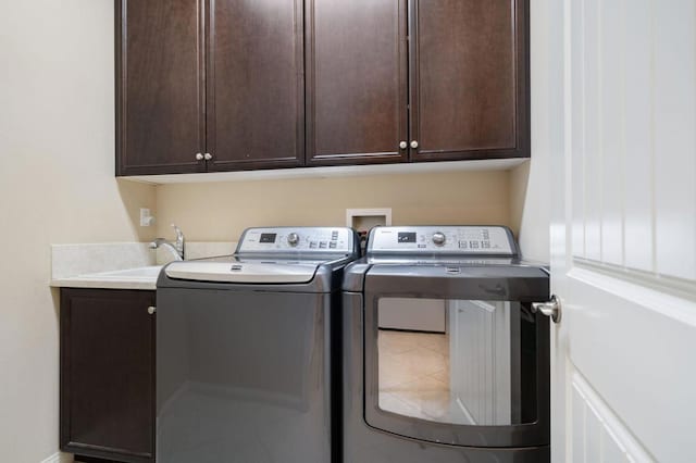 laundry room featuring cabinets, sink, tile patterned floors, and washer and dryer