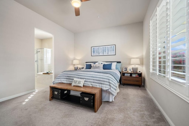 bedroom featuring ensuite bathroom, carpet floors, and ceiling fan