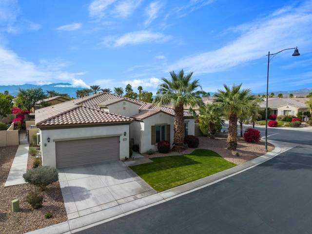 mediterranean / spanish home featuring a mountain view and a garage