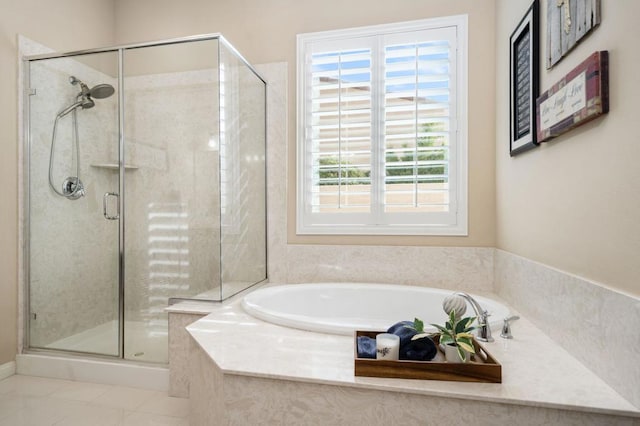 bathroom featuring tile patterned floors and independent shower and bath