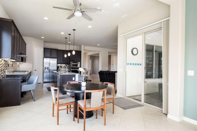 dining space with light tile patterned floors and ceiling fan