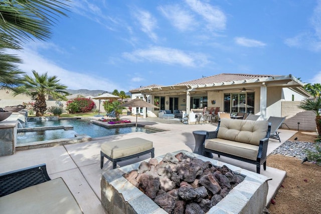 view of pool with pool water feature, a patio area, a hot tub, outdoor lounge area, and ceiling fan