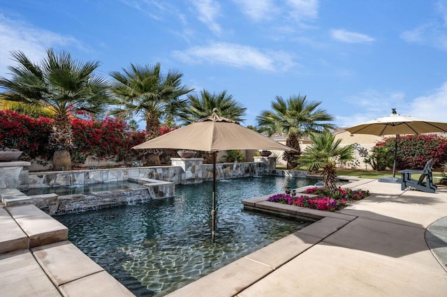 view of pool featuring an in ground hot tub, pool water feature, and a patio area