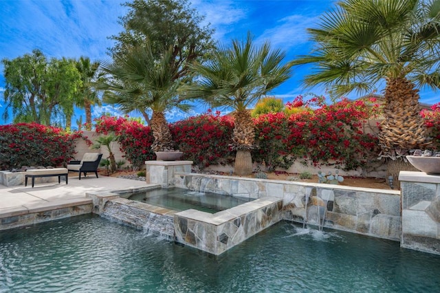 view of pool featuring an in ground hot tub and a patio