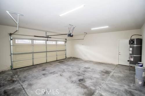 garage featuring a garage door opener and water heater