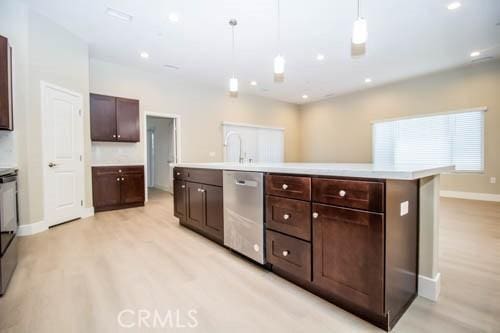 kitchen with pendant lighting, dishwasher, dark brown cabinetry, an island with sink, and light wood-type flooring